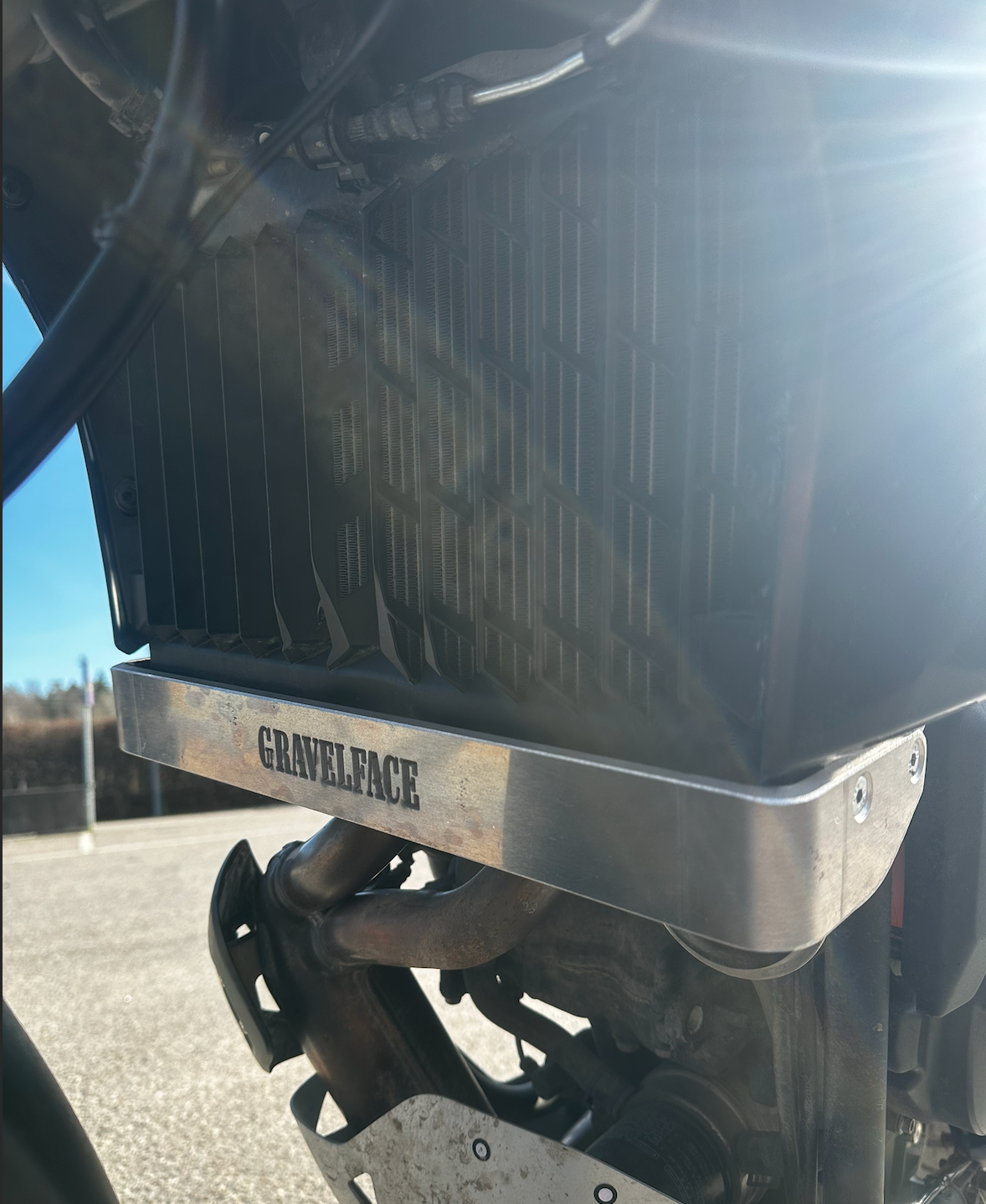 Close-up of a motorcycle radiator brace on Tenere 700 with 'GravelFace'